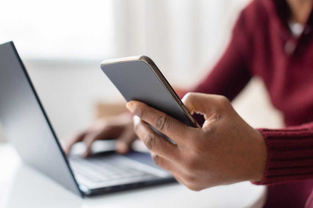 Person with Laptop and Smart Phone